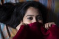 Young Indian brunette woman in sleeping wear lying on a bed Royalty Free Stock Photo