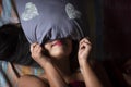 Young Indian brunette woman in white sleeping wear sleeping on a bed Royalty Free Stock Photo