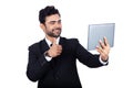 Young Indian businessman showing thumbs up during video call using tablet Royalty Free Stock Photo