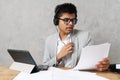 Young indian businessman using tablet and headphones working in office Royalty Free Stock Photo