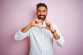 Young Indian Businessman Wearing Elegant Shirt Standing Over Isolated Pink Background Smiling In Love Doing Heart Symbol Shape