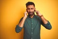 Young indian businessman wearing elegant shirt standing over isolated white background covering ears with fingers with annoyed Royalty Free Stock Photo