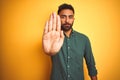 Young indian businessman wearing elegant shirt standing over isolated white background doing stop sing with palm of the hand Royalty Free Stock Photo