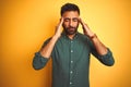 Young indian businessman wearing elegant shirt standing over isolated white background with hand on head for pain in head because Royalty Free Stock Photo