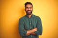 Young indian businessman wearing elegant shirt standing over isolated white background happy face smiling with crossed arms Royalty Free Stock Photo