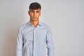 Young indian businessman wearing elegant shirt standing over isolated white background with serious expression on face Royalty Free Stock Photo