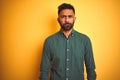 Young indian businessman wearing elegant shirt standing over isolated white background skeptic and nervous, frowning upset because Royalty Free Stock Photo