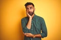 Young indian businessman wearing elegant shirt standing over isolated white background thinking looking tired and bored with Royalty Free Stock Photo