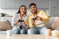 Young Indian Couple Playing Video Games With Joysticks At Home Royalty Free Stock Photo