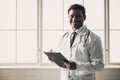 Young Indian Doctor in White Uniform Writing Notes