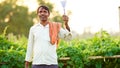 Young Indian farmer at green agriculture field