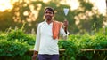 Young Indian farmer at green agriculture field