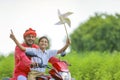 Young indian farmer and little child enjoying bike ride