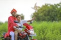 Young indian farmer and little child enjoying bike ride