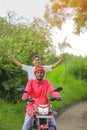 Young indian farmer and little child enjoying bike ride