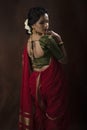 Young Indian female wearing Maharashtrian style red saree