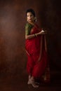 Young Indian female wearing Maharashtrian style red saree