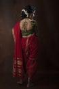 Young Indian female wearing Maharashtrian style red saree