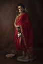 Young Indian female wearing Maharashtrian style red saree