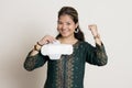 Young indian girl cheering while holding a sanitary pad in her hands and standing on a white isolated background Royalty Free Stock Photo