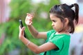 A young indian girl excited watching mobile phone.