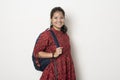 Young indian girl getting ready to go to college, college girl with a bag on white background