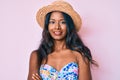 Young indian girl wearing bikini and summer hat happy face smiling with crossed arms looking at the camera Royalty Free Stock Photo