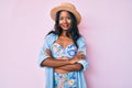 Young indian girl wearing bikini and summer hat happy face smiling with crossed arms looking at the camera Royalty Free Stock Photo