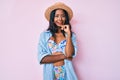 Young indian girl wearing bikini and summer hat smiling looking confident at the camera with crossed arms and hand on chin Royalty Free Stock Photo