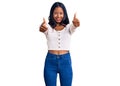 Young indian girl wearing casual clothes approving doing positive gesture with hand, thumbs up smiling and happy for success Royalty Free Stock Photo