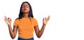 Young indian girl wearing casual clothes and glasses relax and smiling with eyes closed doing meditation gesture with fingers Royalty Free Stock Photo