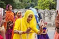 Young Indian girls in traditional sari, dancing at wedding crowd on the street