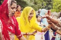 Young Indian girls in traditional sari, dancing at wedding crowd on the street