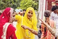 Young Indian girls in traditional sari, dancing at wedding crowd on the street