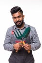 Young indian handsome gardener with tools isolated on white background