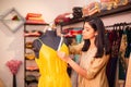 Young indian happy woman,tailor,fashion designer,dressmaker seamstress checking measurements and fitting of dress of shoulder area