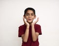 Young Indian kid acting surprised white standing on a white wall with copy space. Education and fun concept