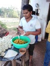 Young Indian man cooking samosa fast food in Morjim, Goa, India