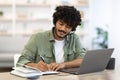 Young indian man having online training, home interior Royalty Free Stock Photo