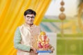 Young Indian man with Lord Ganesha , Celebrating Ganesh festival