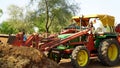 Young Indian man operate new tractor with loder. Agriculture with modern technology