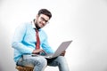 Young Indian man on spectacles and using laptop Royalty Free Stock Photo