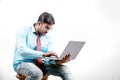 Young Indian man on spectacles and using laptop Royalty Free Stock Photo