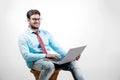 Young Indian man on spectacles and using laptop Royalty Free Stock Photo