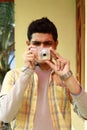 Young Indian Man Taking Photo in Digital Camera Royalty Free Stock Photo