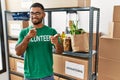 Young indian man volunteer holding donations box pointing fingers to camera with happy and funny face Royalty Free Stock Photo