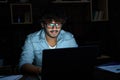 Young indian man working late at night using laptop computer. Royalty Free Stock Photo