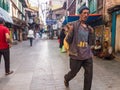 A young Indian porter walking through a market