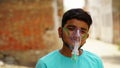 Young Indian taking Emergency Oxygen with Cannula outside of hospital