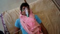 Young Indian taking Emergency Oxygen with Cannula outside of hospital. Severe causes due to Covid in India concept